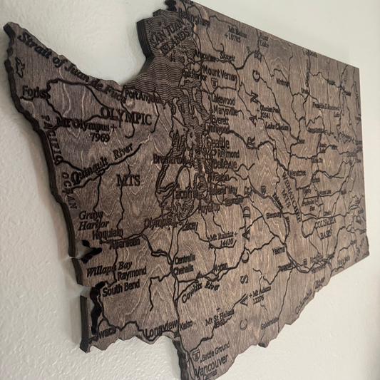 Wooden map of Washington state on a white wall